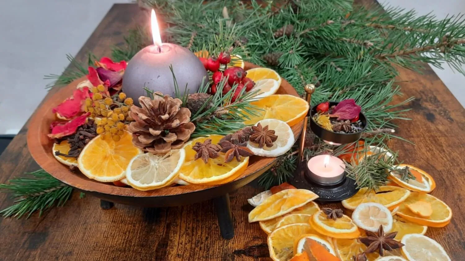 Adventní mísa s hořící svíčkou, sušenými pomeranči, šiškami a chvojím